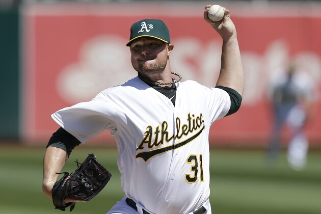 Oakland Athletics pitcher Jon Lester (31) throws against the Seattle Mariners during the first inning of a baseball game in Oakland, Calif., Wednesday, Sept. 3, 2014. (AP Photo/Jeff Chiu)