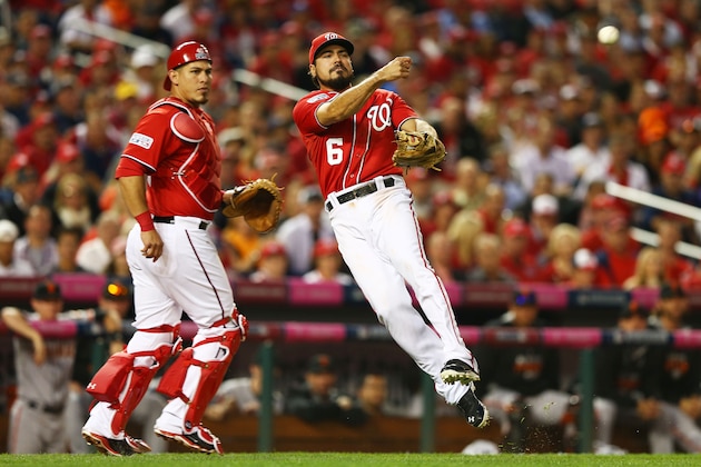 WASHINGTON, DC - OCTOBER 03:  Anthony Rendon #6 of the Washington Nationals fields a ball to first but fails to get the out on Gregor Blanco #7 of the San Francisco Giants in the ninth inning during Game One of the National League Division Series at Nationals Park on October 3, 2014 in Washington, DC.  (Photo by Elsa/Getty Images)