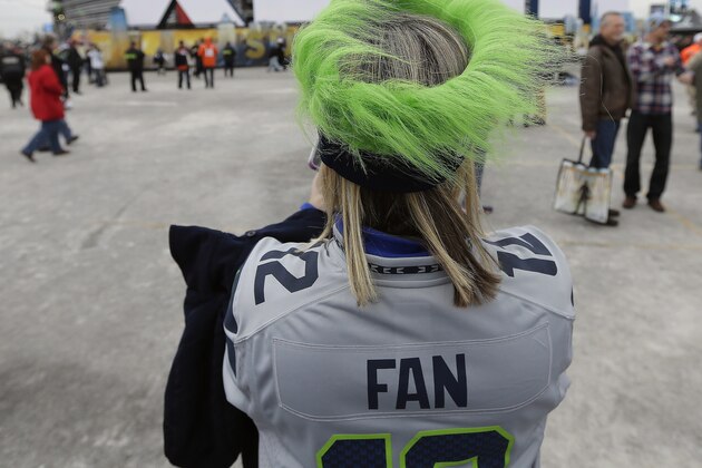 Seattle Seahawks fan Shirley Wolff, of Puyallup, Wash., takes a photo outside MetLife Stadium before the NFL Super Bowl XLVIII football game between the Seattle Seahawks and the Denver Broncos, Sunday, Feb. 2, 2014, in East Rutherford, N.J. (AP Photo/Charlie Riedel)