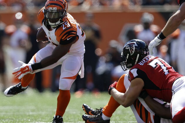 Cincinnati Bengals running back Giovani Bernard (25) runs past Atlanta Falcons outside linebacker Kroy Biermann in the first half of an NFL football game, Sunday, Sept. 14, 2014, in Cincinnati. (AP Photo/Michael Conroy)