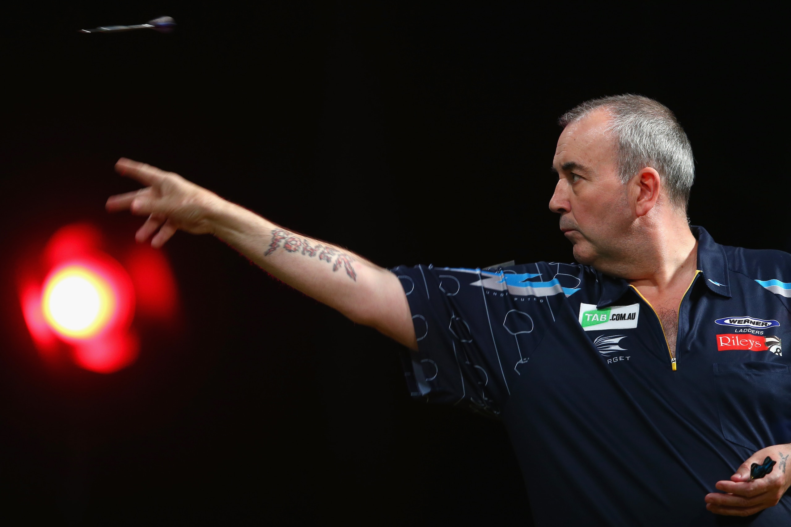 SYDNEY, AUSTRALIA - AUGUST 29:  Phil Taylor of England competes in his quarter-final match against Dave Chisnall of England during the Sydney Darts Masters at Hordern Pavilion on August 29, 2014 in Sydney, Australia.  (Photo by Mark Kolbe/Getty Images)
