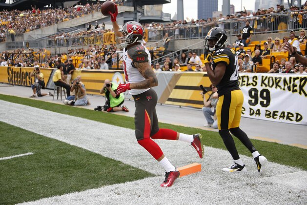 Tampa Bay Buccaneers wide receiver Mike Evans (13) celebrates after catching a touchdown pass as Pittsburgh Steelers cornerback Cortez Allen (28) defends in the first quarter of the NFL football game on Sunday, Sept. 28, 2014 in Pittsburgh. (AP Photo/Gene Puskar)