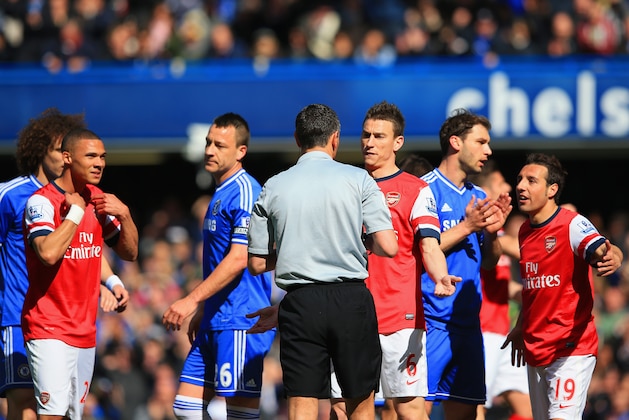 LONDON, ENGLAND - MARCH 22:  Kieran Gibbs (L) and Laurent Koscielny, Santi Cazorla of Arsenal appeal to Referee Andre Marriner after Kieran Gibbs of Arsenal  received a red card during the Barclays Premier League match between Chelsea and Arsenal at Stamford Bridge on March 22, 2014 in London, England.  (Photo by Richard Heathcote/Getty Images)
