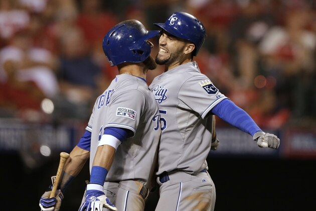 Kansas City Royals' Eric Hosmer, right, celebrates his two-run home run with Alex Gordon in the 11th inning against the Los Angeles Angels in Game 2 of baseball's AL Division Series, in Anaheim, Calif., Friday, Oct. 3, 2014. (AP Photo/Gregory Bull)