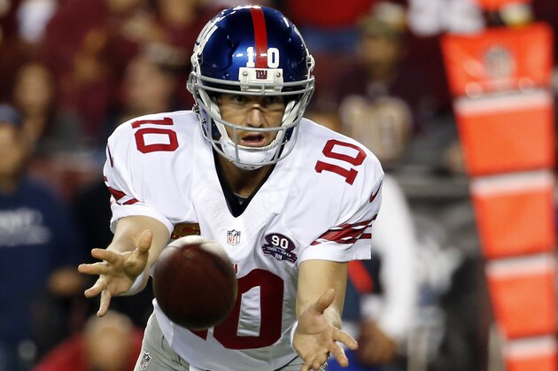 New York Giants quarterback Eli Manning (10) laterals the ball during the second half of an NFL Thursday night football game against the New York Giants in Landover, Md., Thursday, Sept. 25, 2014. (AP Photo/Alex Brandon)