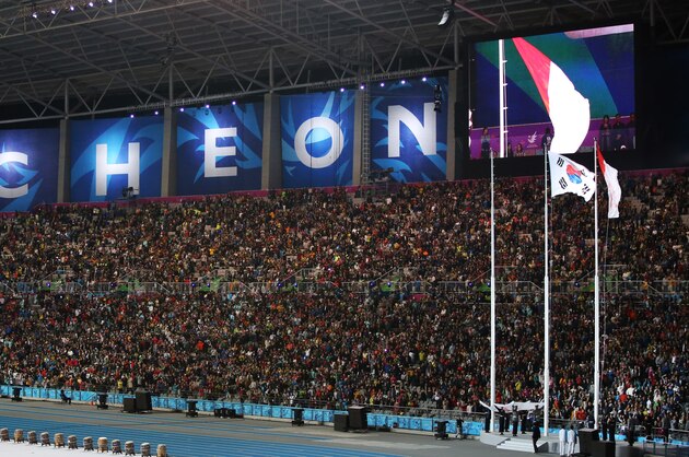 Indonesia's national flag, right, flutters next the South Korea's national flag during the closing ceremony for the 17th Asian Games in Incheon, South Korea, Saturday, Oct. 4, 2014. (AP Photo/Eugene Hoshiko)