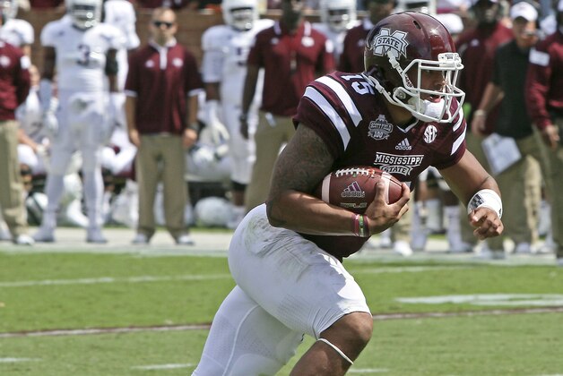 Mississippi State quarterback Dak Prescott (15) gains additional yardage after receiving a pass during the first half of an NCAA college football game against Texas A&M in Starkville, Miss., Saturday, Oct. 4, 2014. (AP Photo/Jim Lytle)