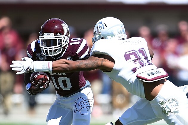 STARKVILLE, MS - OCTOBER 04:  Brandon Holloway #10 of the Mississippi State Bulldogs is pursued by Howard Matthews #31 of the Texas A&M Aggies during the second quarter of a game at Davis Wade Stadium on October 4, 2014 in Starkville, Mississippi.  (Photo by Stacy Revere/Getty Images)