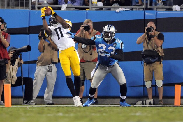 Pittsburgh Steelers' Markus Wheaton (11) catches a pass as Pittsburgh Steelers' Mike Mitchell (23) defends during the first half of an NFL football game in Charlotte, N.C., Sunday, Sept. 21, 2014. The play was ruled incomplete since Wheaton stepped out of bounds before catching the ball. (AP Photo/Mike McCarn)