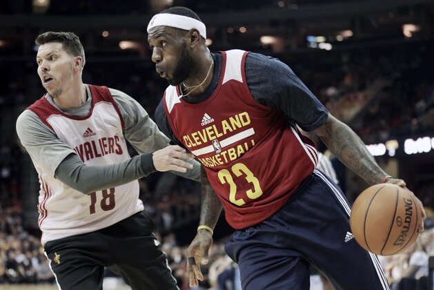 Cleveland Cavaliers' LeBron James (23) drives past Mike Miller (18) during an NBA scrimmage basketball game Wednesday, Oct. 1, 2014, in Cleveland. (AP Photo/Tony Dejak)