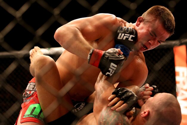 Jul 16, 2014; Atlantic City, NJ, USA; Rick Story (red gloves) grapples with Leonardo Mafra (blue gloves) during a welterweight bout at Revel Casino. Mandatory Credit: Bill Streicher-USA TODAY Sports