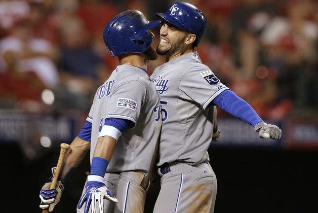 Kansas City Royals' Eric Hosmer, right, celebrates his two-run home run with Alex Gordon in the 11th inning against the Los Angeles Angels in Game 2 of baseball's AL Division Series, in Anaheim, Calif., Friday, Oct. 3, 2014. (AP Photo/Gregory Bull)