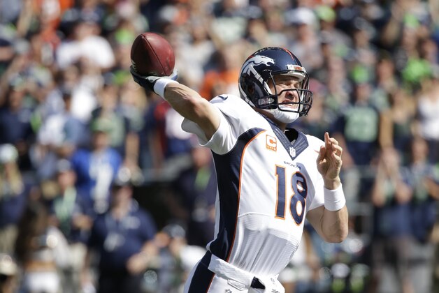 Denver Broncos quarterback Peyton Manning passes in the first half of an NFL football game against the Seattle Seahawks, Sunday, Sept. 21, 2014, in Seattle. (AP Photo/Elaine Thompson)