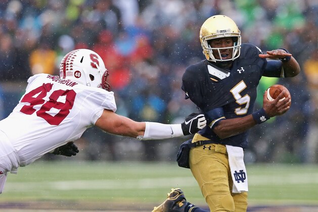 SOUTH BEND, IN - OCTOBER 04:  Everett Golson #5 of the Notre Dame Fighting Irish breaks away from Kevin Anderson #48 of the Standford Cardinal at Notre Dame Stadium on October 4, 2014 in South Bend, Indiana.  (Photo by Jonathan Daniel/Getty Images)