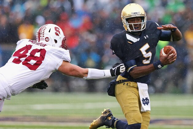 SOUTH BEND, IN - OCTOBER 04:  Everett Golson #5 of the Notre Dame Fighting Irish breaks away from Kevin Anderson #48 of the Standford Cardinal at Notre Dame Stadium on October 4, 2014 in South Bend, Indiana.  (Photo by Jonathan Daniel/Getty Images)