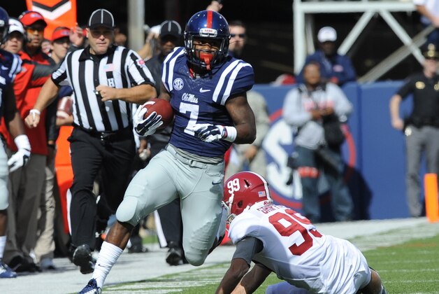 Oct 4, 2014; Oxford, MS, USA; Mississippi Rebels running back Mark Dodson (7) returns the opening kickoff for 58 yards during the first half against Alabama Crimson Tide at Vaught-Hemingway Stadium. Mandatory Credit: Christopher Hanewinckel-USA TODAY Sports