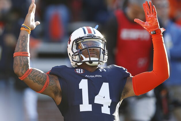 Auburn quarterback Nick Marshall (14) stretches before an NCAA college football game against LSU on Saturday, Oct. 4, 2014, in Auburn, Ala. (AP Photo/Brynn Anderson)
