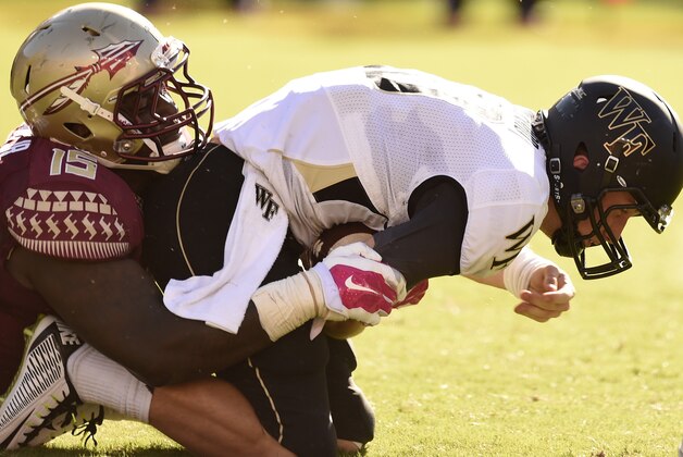 Oct 4, 2014; Tallahassee, FL, USA; Florida State Seminoles defensive end Mario Edwards Jr. (15) sacks Wake Forest Demon Deacons quarterback John Wolford (10) for a loss during the second quarter at Doak Campbell Stadium. Mandatory Credit: John David Mercer-USA TODAY Sports