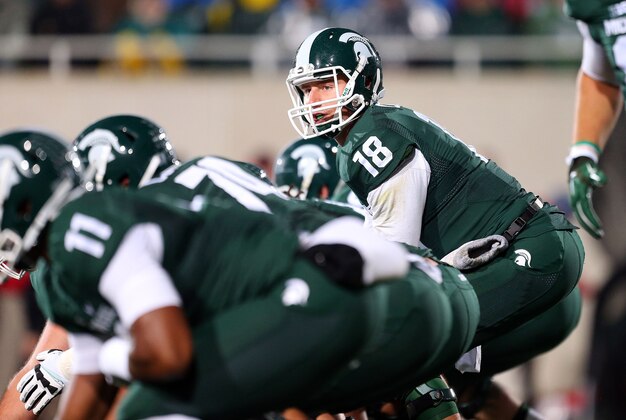 Oct 4, 2014; East Lansing, MI, USA; Michigan State Spartans quarterback Connor Cook (18) prepares to take the snap of the ball from Michigan State Spartans center Jack Allen (66)during the 1st quarter of a game at Spartan Stadium. Mandatory Credit: Mike Carter-USA TODAY Sports