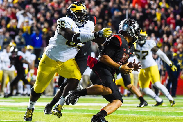 PISCATAWAY, NJ - OCTOBER 04: Gary Nova #10 of the Rutgers Scarlet Knights is sacked by Willie Henry #69 of the Michigan Wolverines in the third quarter at High Point Solutions Stadium on October 4, 2014 in Piscataway, New Jersey.  (Photo by Alex Goodlett/Getty Images)