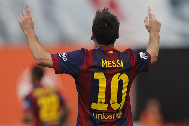 Barcelona's Lionel Messi celebrates his goal  during a Spanish La Liga soccer match between Rayo Vallecano and FC Barcelona at the Vallecas stadium in Madrid, Spain, Saturday, Oct. 4, 2014. (AP Photo/Andres Kudacki)