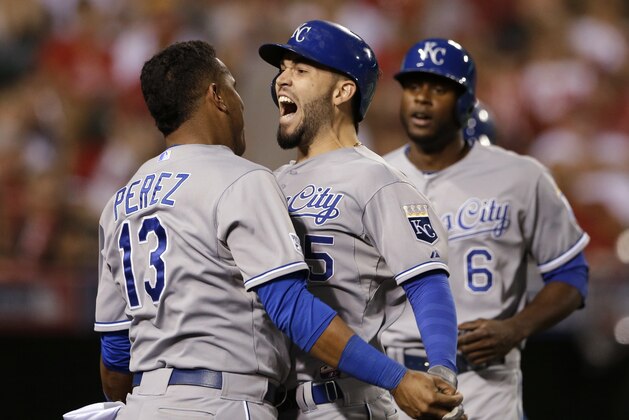 Kansas City Royals' Eric Hosmer, center, celebrates his two-run home run with Salvador Perez, left, in the 11th inning against the Los Angeles Angels in Game 2 of baseball's AL Division Series, in Anaheim, Calif., Friday, Oct. 3, 2014. (AP Photo/Gregory Bull)