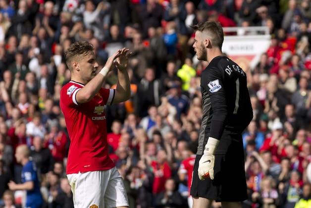 Manchester United's goalkeeper David De Gea, right, is congratulated by teammate Luke Shaw after saving a penalty conceded by the former after a foul on Everton's Tony Hibbert during their English Premier League soccer match at Old Trafford Stadium, Manchester, England, Sunday Oct. 5, 2014. (AP Photo/Jon Super)
