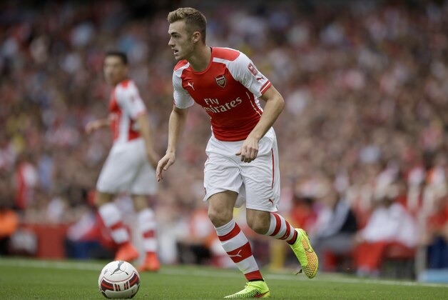 Arsenal's Calum Chambers controls the ball as he makes his debut during the Emirates Cup soccer match between Arsenal and Benfica at Arsenal's Emirates Stadium in London, Saturday, Aug. 2, 2014.  (AP Photo/Matt Dunham)