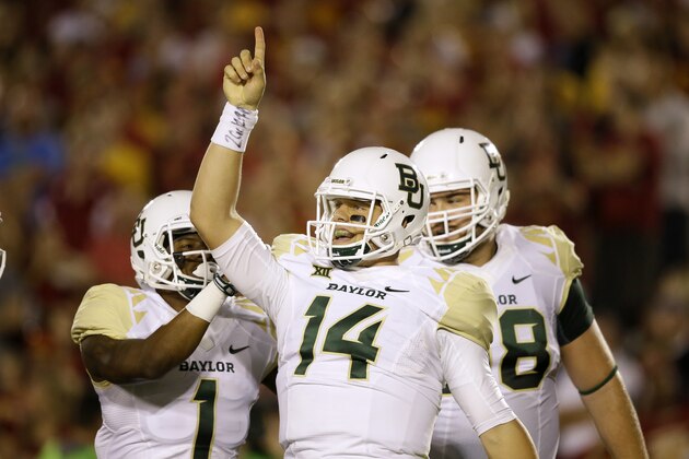 Baylor quarterback Bryce Petty (14) celebrates with teammates after scoring a touchdown during the first half of an NCAA college football game against Iowa State, Saturday, Sept. 27, 2014, in Ames, Iowa. (AP Photo/Charlie Neibergall)