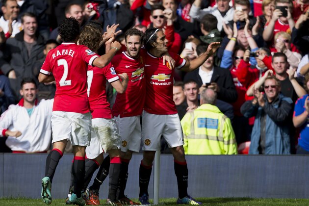 Manchester United's Radamel Falcao Garcia, right, celebrates with teammates after scoring against Everton during their English Premier League soccer match at Old Trafford Stadium, Manchester, England, Sunday Oct. 5, 2014. (AP Photo/Jon Super)