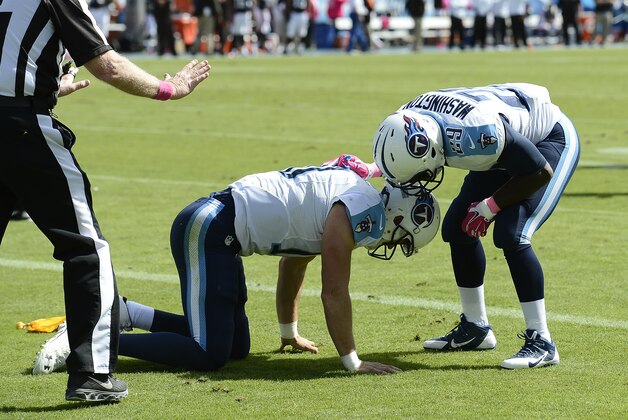 Tennessee Titans quarterback Jake Locker (10) is looked over by running back Leon Washington (29) after Locker scored a touchdown on an 11-yard run against the Cleveland Browns in the second quarter of an NFL football game Sunday, Oct. 5, 2014, in Nashville, Tenn. (AP Photo/Mark Zaleski)