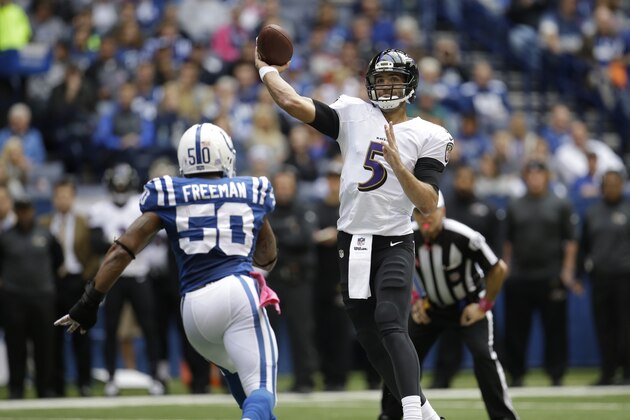 Baltimore Ravens quarterback Joe Flacco throws over Indianapolis Colts inside linebacker Jerrell Freeman during the first half of an NFL football game in Indianapolis, Sunday, Oct. 5, 2014. (AP Photo/AJ Mast)