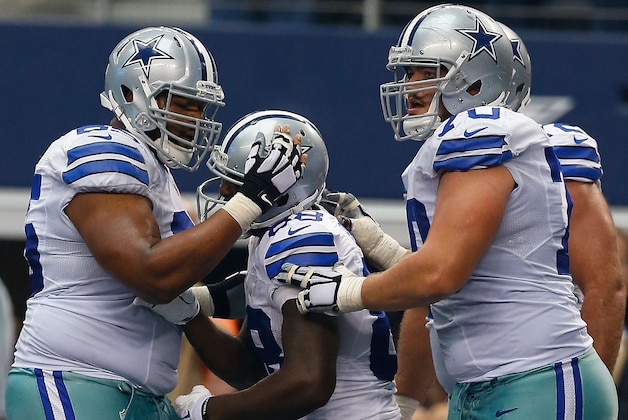 ARLINGTON, TX - OCTOBER 05:  Dez Bryant #88 of the Dallas Cowboys celebrates his touchdown catch with Ronald Leary #65 of the Dallas Cowboys and Zack Martin #70 of the Dallas Cowboys  in the second half at AT&T Stadium on October 5, 2014 in Arlington, Texas.  (Photo by Tom Pennington/Getty Images)