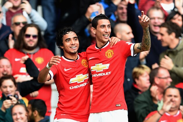 MANCHESTER, ENGLAND - OCTOBER 05:  Angel Di Maria of Manchester United celebrates scoring the first goal with Rafael (L) during the Barclays Premier League match between Manchester United and Everton at Old Trafford on October 5, 2014 in Manchester, England.  (Photo by Michael Regan/Getty Images)