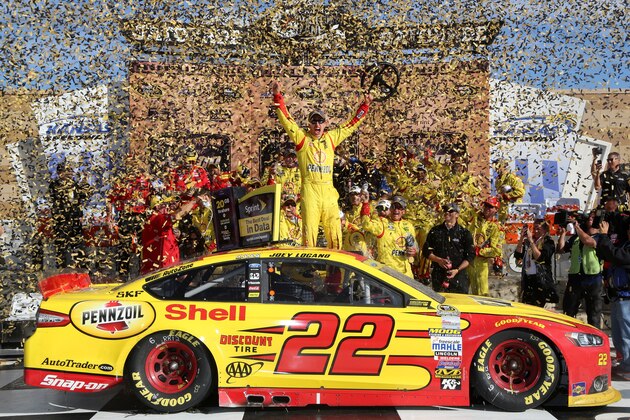 KANSAS CITY, KS - OCTOBER 05:  Joey Logano, driver of the #22 Shell-Pennzoil Ford, celebrates in Victory Lane after winning the NASCAR Sprint Cup Series Hollywood Casino 400 at Kansas Speedway on October 5, 2014 in Kansas City, Kansas.  (Photo by Jerry Markland/Getty Images)