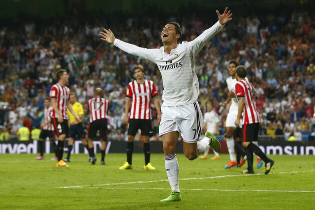 Real's Cristiano Ronaldo, right, celebrates his third goal, during a Spanish La Liga soccer match between Real Madrid and Athletic Bilbao at the Santiago Bernabeu stadium in Madrid, Spain, Sunday, Oct. 5, 2014. (AP Photo/Andres Kudacki)