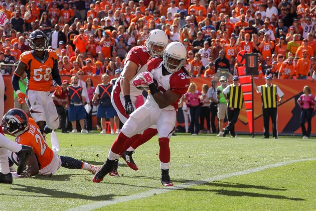 DENVER, CO - OCTOBER 5:  Running back Andre Ellington #38 of the Arizona Cardinals has a 5-yard second quarter rushing touchdown against the Denver Broncos during a game at Sports Authority Field at Mile High on October 5, 2014 in Denver, Colorado.  (Photo by Doug Pensinger/Getty Images)
