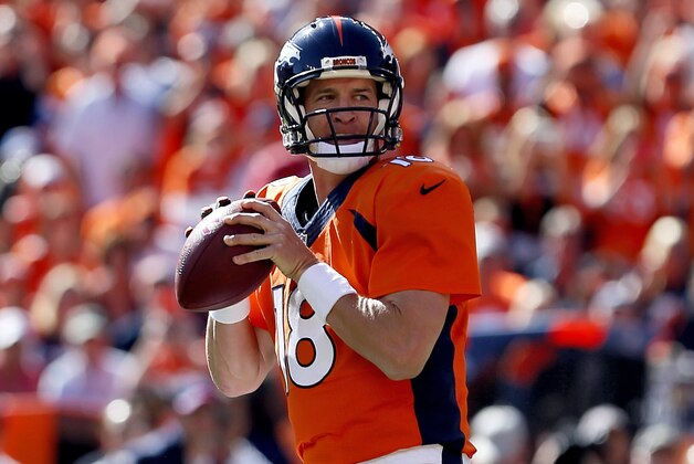 Denver Broncos quarterback Peyton Manning (18) get ready to throw his 500th career touchdown pass during the first half of an NFL football game against the Arizona Cardinals, Sunday, Oct. 5, 2014, in Denver. (AP Photo/Joe Mahoney)