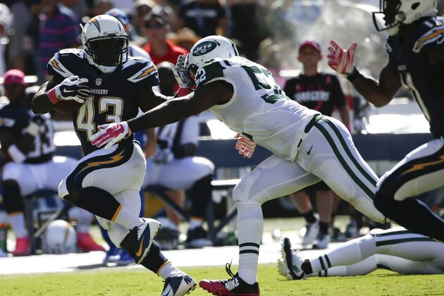 San Diego Chargers running back Branden Oliver runs past New York Jets inside linebacker David Harris during the first half of an NFL football game, Sunday, Oct. 5, 2014, in San Diego. (AP Photo/Lenny Ignelzi)