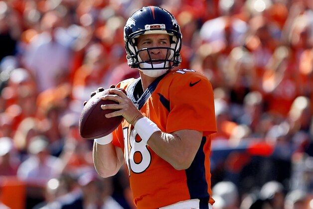 Denver Broncos quarterback Peyton Manning (18) get ready to throw his 500th career touchdown pass during the first half of an NFL football game against the Arizona Cardinals, Sunday, Oct. 5, 2014, in Denver. (AP Photo/Joe Mahoney)
