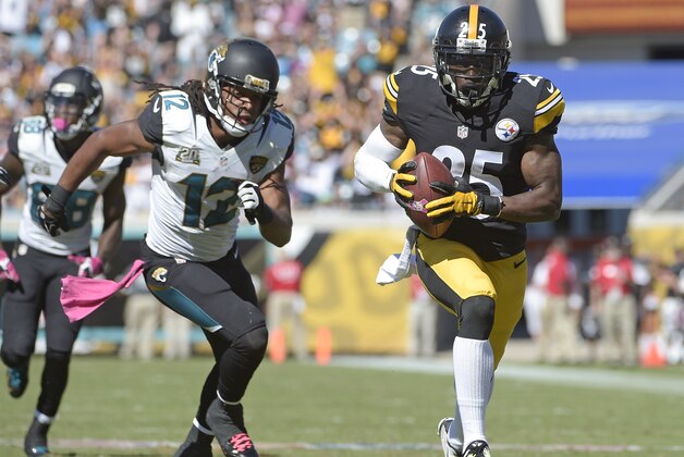 Pittsburgh Steelers cornerback Brice McCain, right, returns an intercepted pass 22-yards for a touchdown in front of Jacksonville Jaguars wide receiver Mike Brown (12) during the second half of an NFL football game in Jacksonville, Fla., Sunday, Oct. 5, 2014. (AP Photo/Phelan M. Ebenhack)