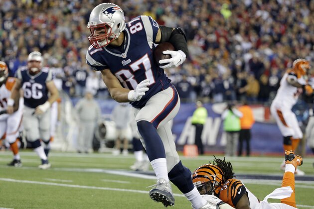 New England Patriots tight end Rob Gronkowski (87) runs after catching a pass from Tom Brady in the first half of an NFL football game against the Cincinnati Bengals Sunday, Oct. 5, 2014, in Foxborough, Mass. With the completion, Brady becomes the sixth quarterback in NFL history to throw for 50,000 career passing yards. (AP Photo/Steven Senne)
