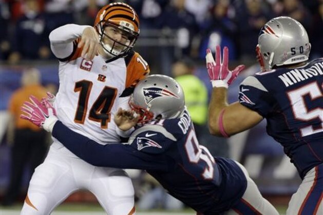 New England Patriots outside linebacker Jamie Collins (91) hits Cincinnati Bengals quarterback Andy Dalton (14) after he released a pass in the first half of an NFL football game Sunday, Oct. 5, 2014, in Foxborough, Mass. (AP Photo/Stephan Savoia)