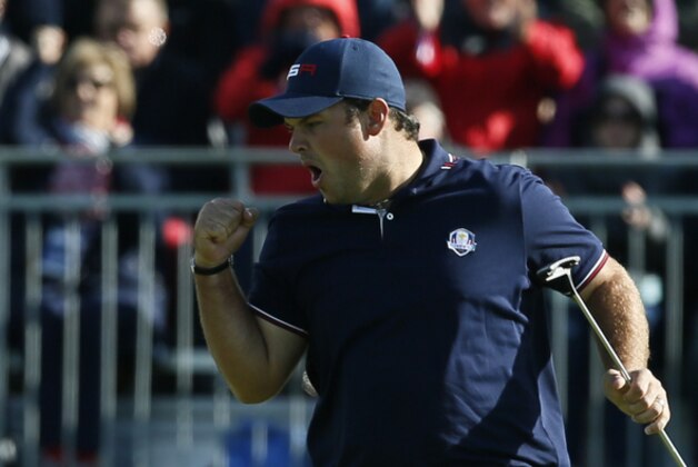 Patrick Reed of the US celebrate putting to win the 13th green during the fourball match on the second day of the Ryder Cup golf tournament at Gleneagles, Scotland, Saturday, Sept. 27, 2014. (AP Photo/Alastair Grant)