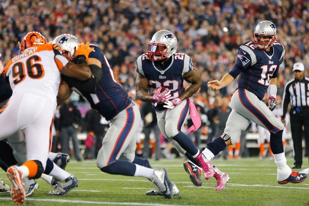 FOXBORO, MA - OCTOBER 05:  Tom Brady #12 hands off as Stevan Ridley #22 of the New England Patriots scores a touchdown during the first quarter against the Cincinnati Bengals at Gillette Stadium on October 5, 2014 in Foxboro, Massachusetts.  (Photo by Jim Rogash/Getty Images)