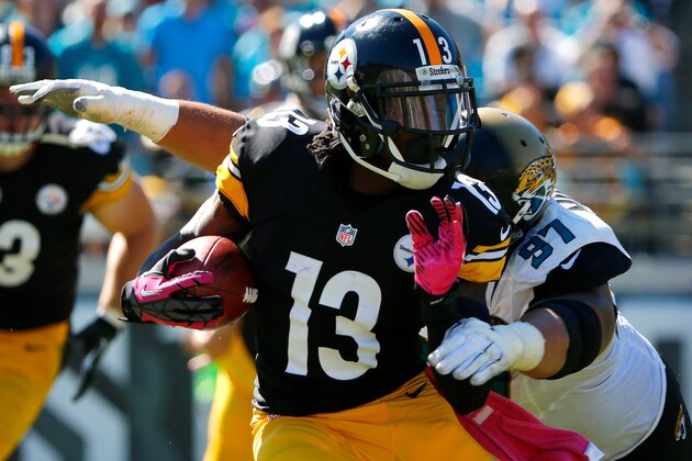 JACKSONVILLE, FL - OCTOBER 05:  Roy Miller #97 of the Jacksonville Jaguars attempts to tackle  Dri Archer #13 of the Pittsburgh Steelers during the game at EverBank Field on October 5, 2014 in Jacksonville, Florida.  (Photo by Sam Greenwood/Getty Images)