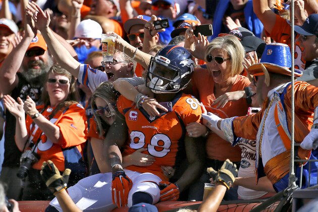 Denver Broncos wide receiver Demaryius Thomas (88) celebrates his touchdown with fans against the Arizona Cardinals during the first half of an NFL football game, Sunday, Oct. 5, 2014, in Denver. (AP Photo/Jack Dempsey)