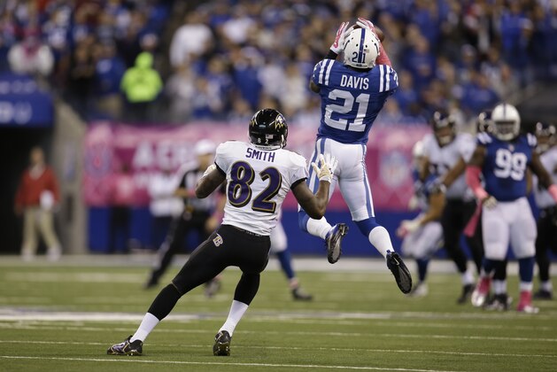 Indianapolis Colts cornerback Vontae Davis (21) intercepts a pass intended for Baltimore Ravens wide receiver Torrey Smith during the second half of an NFL football game in Indianapolis, Sunday, Oct. 5, 2014. (AP Photo/AJ Mast)