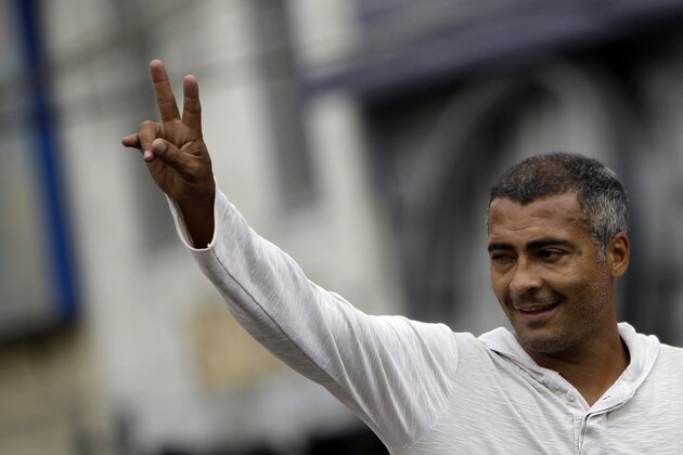 Brazil's former soccer player and candidate for the Federal Congress, Romario, gestures to supporters as he campaigns in Sao Joao de Meriti, Brazil, Wednesday, Sept. 29, 2010. Brazil will hold general elections on Oct. 3. (AP Photo/Felipe Dana)