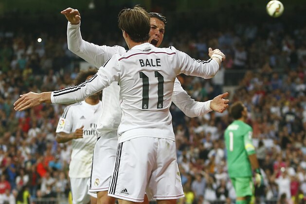 Real's Cristiano Ronaldo, centre , celebrates his goal with Gareth Bale, foreground,  during the Spanish La Liga soccer match between Real Madrid and Athletic Bilbao at the Santiago Bernabeu stadium in Madrid, Spain, Sunday, Oct. 5, 2014. (AP Photo/Andres Kudacki)